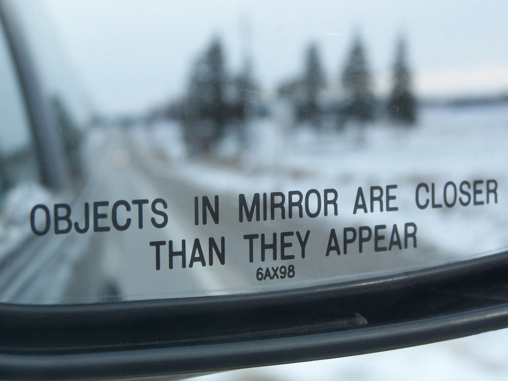 Objects In Mirror Are Closer Than They Appear Logo